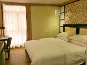 Voodi või voodid majutusasutuse Guangzhou Bird Island Hotel toas