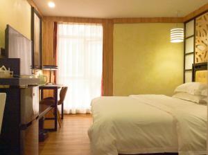 Voodi või voodid majutusasutuse Guangzhou Bird Island Hotel toas