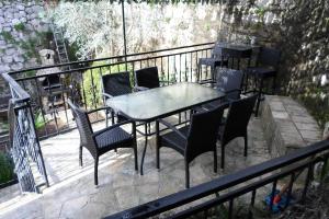 a patio with a table and chairs on a balcony at Holiday Home Stone House in Perast
