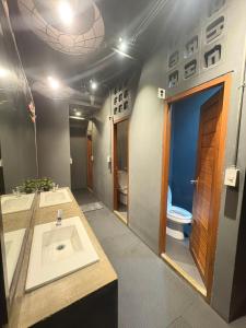 a bathroom with two sinks and a toilet at BANKBED Hostel in Bangkok +30 photos