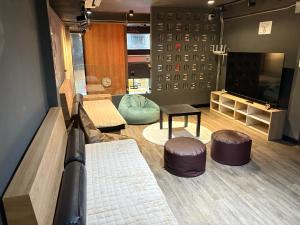 a room with two ottomans and two stools at BANKBED Hostel in Bangkok