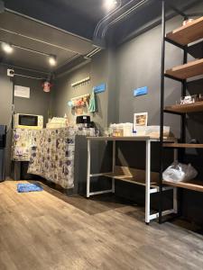 a store with a table and shelves in a room at BANKBED Hostel in Bangkok