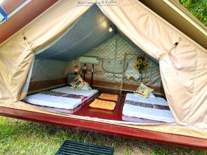 a tent with two beds and towels in it at Hen Camping- Coffee --------- Free if you have tent in Ninh Binh