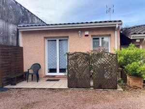 a house with a chair and a fence in front of it at Tucaut in Toulouse +5 photos