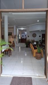 a lobby with a couch and tables in a building at Pondok Ganda in Ambarita