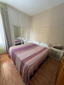 a bedroom with a bed with a striped blanket at Orlando Costa Adeje in Adeje +24 photos