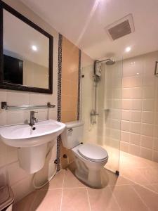 a bathroom with a toilet and a sink and a shower at Rommai Greenpark in Lampang +90 photos