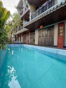 a swimming pool in front of a building at KunKin Boutique Garden Hue in Thôn Dương Xuân Hạ