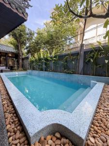 a swimming pool in the middle of a house at KunKin Boutique Garden Hue in Thôn Dương Xuân Hạ