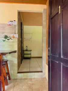 a door leading into a room with a table at Cabinas Arenal Z-13 in Fortuna