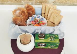 a tray of food with bread and pastries and a cup of coffee at Cosy Open Space Apartment Bari in Bari