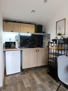 a kitchen with a sink and a counter top at Dax Jardin Studio in Dax