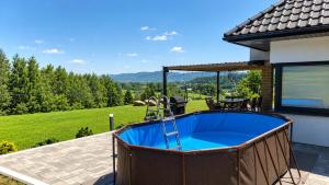 a hot tub on the patio of a house at Wichrowe Wzgórze dom na wyłączność 5 sypialni Kraków 50 min in Tworkowa