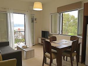 a living room with a table and a couch at Demeliza Apartments in Plaka