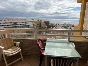 a table and chairs on a balcony with a view at Orlando Costa Adeje in Adeje