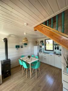 a kitchen and dining room with a table and chairs at Morze Lubiatowo in Lubiatowo