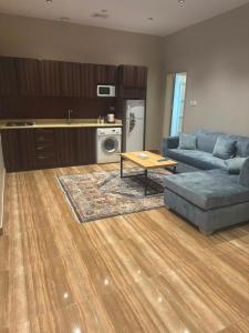 a living room with a couch and a table at منتجع اغصان الشفا in Ash Shafa