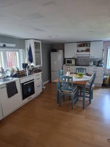 a kitchen with a table and chairs in a room at Navetta in Salo