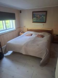 a bedroom with a white bed with two pillows on it at Navetta in Salo