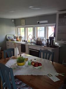 a kitchen with a table with fruits and vegetables on it at Navetta in Salo
