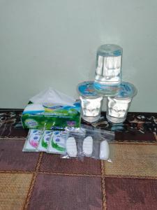 a table with medicines and water and drinking glasses at Hotel Sutera Maju in Kota Kinabalu