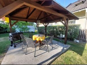 a patio with a table and chairs and a grill at U Melicherů in Suchdol nad Lužnicí +4 photos