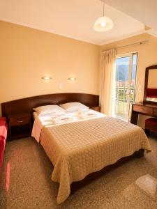 a bedroom with a large bed and a window at Kalias Hotel in Vasiliki +181 photos