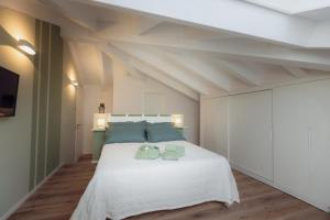 a bedroom with a white bed with two towels on it at Casa dei Bruschi in Casarza Ligure +40 photos