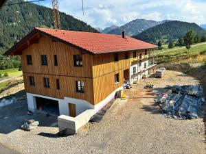 a house under construction on a mountain at Ferienhof Haug in Bad Hindelang
