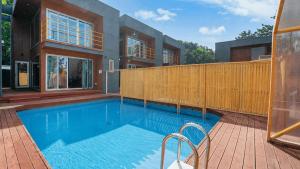 a large swimming pool in front of a house at Uljin 207 Mile Pool Villa in Uljin