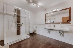 a bathroom with a shower and a sink and a toilet at Landhaus Waldesruh in Oetz +19 photos