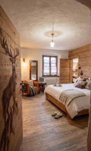 a bedroom with a bed and a living room at Le Orme in Tenno