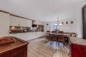 a kitchen and dining room with a table and chairs at Landhaus Waldesruh in Oetz