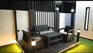 a living room with two chairs and a bench at Meria town attock in Attock