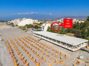 an overhead view of a building with a group of umbrellas at DaMa s Apartment on the beach in Giardini Naxos