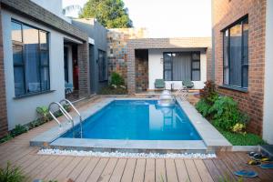 a swimming pool in the backyard of a house at Juney Villas Zanzibar in Zanzibar City