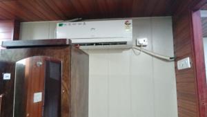 a room with a air conditioner on the wall at Hotel Garden Lodging And Boarding in Ulhāsnagar