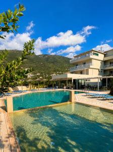 a large swimming pool in front of a building at Kalias Hotel in Vasiliki