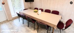 a conference room with a table and red chairs at Vilimu Sodyba - White Hall in Kriukai