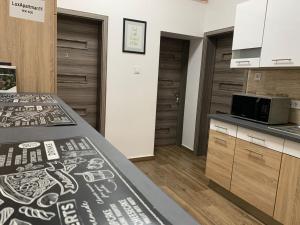 a kitchen with a counter top and a microwave at Downtown Cosy-Rooms in Miskolc