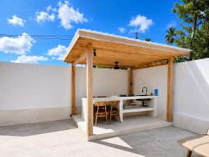 a pergola on a patio with a table at Villa Marieta - Two Bedrooms Private Villa in Kuta Lombok +16 photos