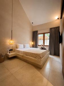 a bedroom with a large bed and a window at Villa Marieta - Two Bedrooms Private Villa in Kuta Lombok
