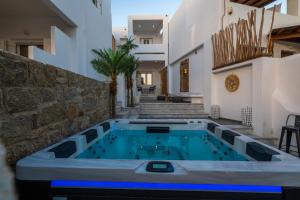 a swimming pool in the middle of a house at Double Mini Suites Adults Only in Ano Mera