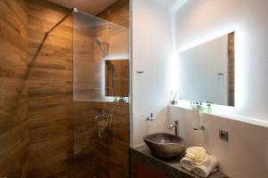 a bathroom with a sink and a glass shower at Double Mini Suites Adults Only in Ano Mera +14 photos