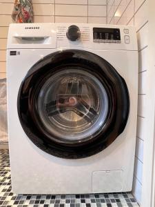 a white washing machine sitting in a room at Apartment close to city center in Haugesund