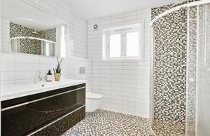 a bathroom with a shower and a sink and a toilet at Apartment close to city center in Haugesund