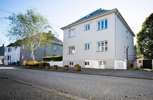 a white house on the side of a street at Apartment close to city center in Haugesund