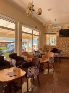 a restaurant with tables and chairs in a room at Hotel Max in Baošići