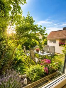 a view of a garden with a table and chairs at Ferienwohnung Wald-Michelbach in Wald-Michelbach