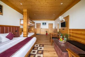 a bedroom with two beds and a tv in a room at JK Dream View Kufri in Kūfrī +79 photos